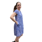 Woman wearing a blue patterned dress on a white background