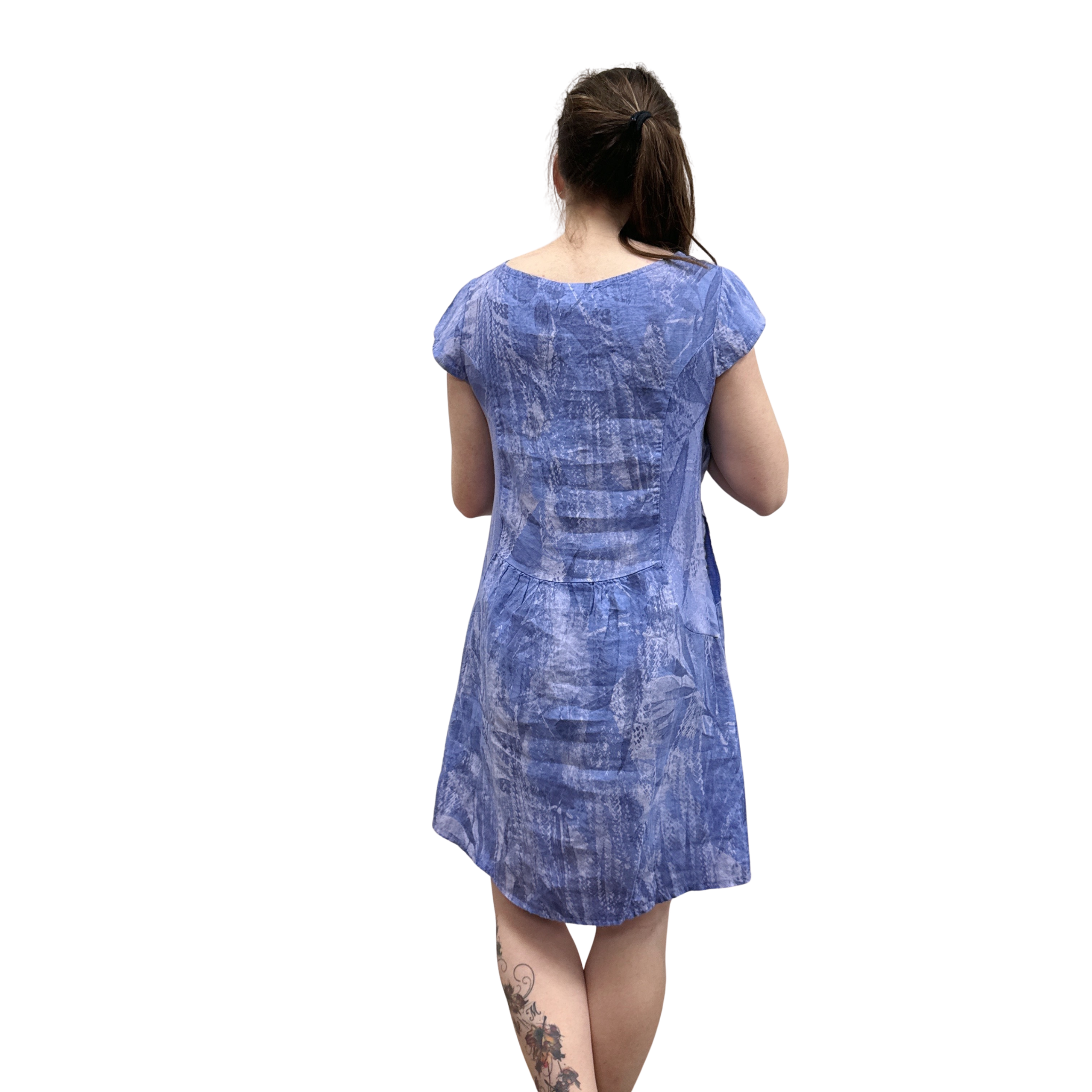 Woman wearing a blue patterned dress on a white background