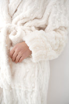 Close-up of Sensis Solene Ivory robe soft plush fabric and textured sleeves