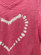 White heart design on a pink fabric background