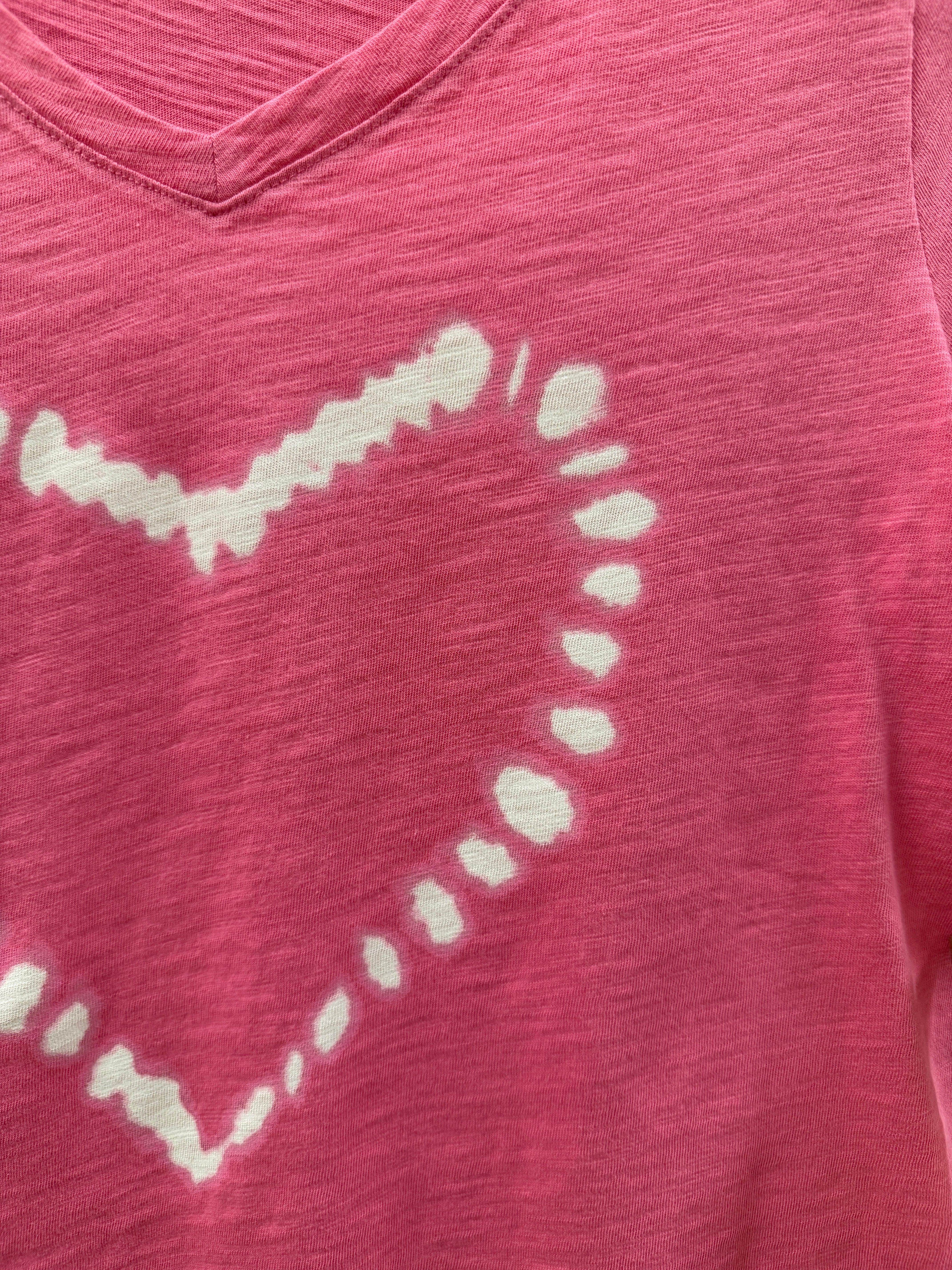 White heart design on a pink fabric background
