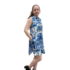 Woman wearing a blue and white patterned dress on a white background