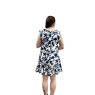 Woman wearing a blue floral dress on a white background