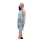 Woman wearing a blue floral tank and short set on a white background