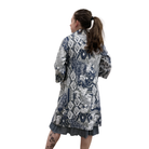 Woman wearing a patterned dress with a white background