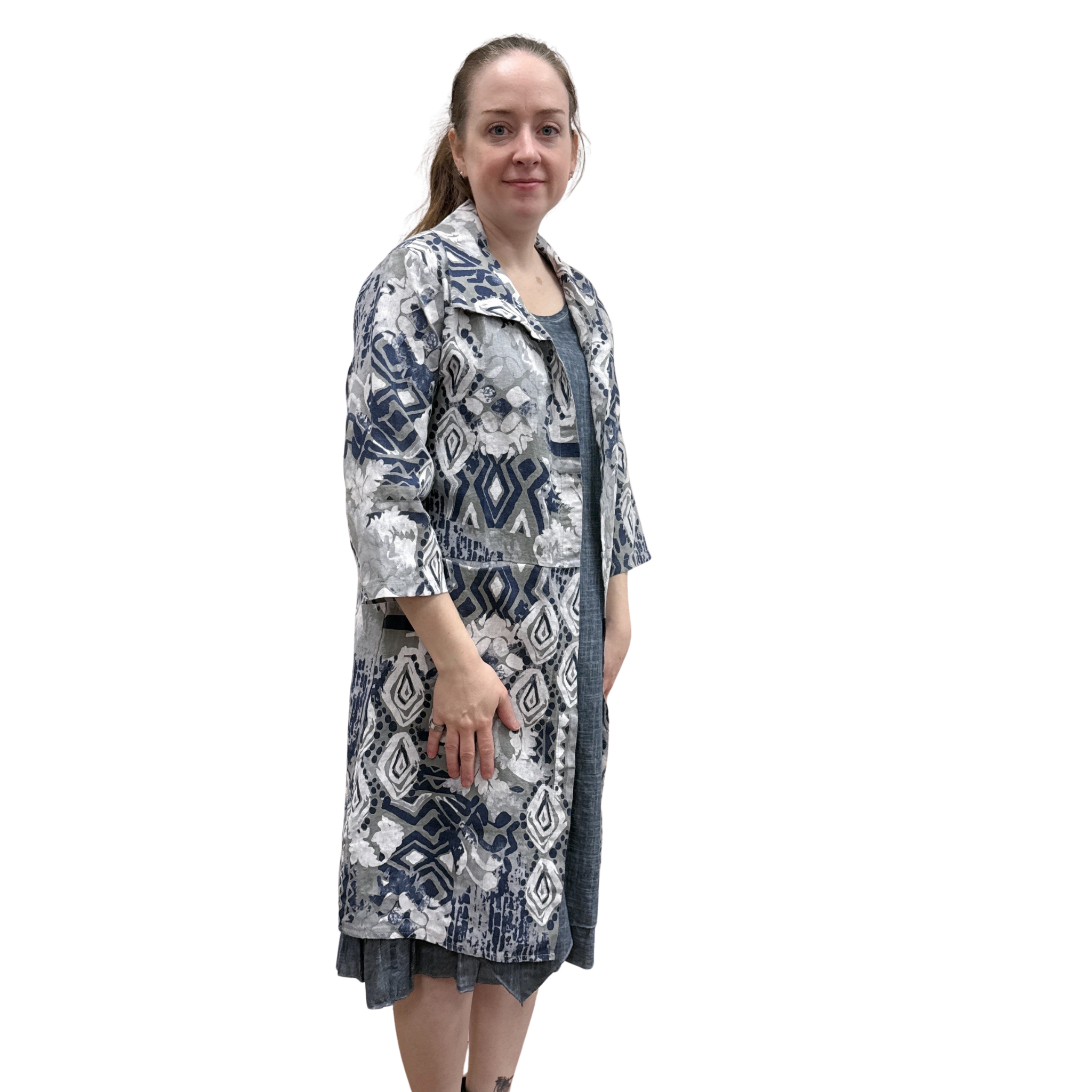 Woman wearing a patterned coat on a white background