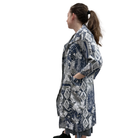 Woman wearing a long, patterned coat on a white background