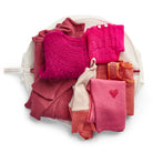 Eco wash bag with contents on top to show how many items the generously sized wash bag can fit at once. 