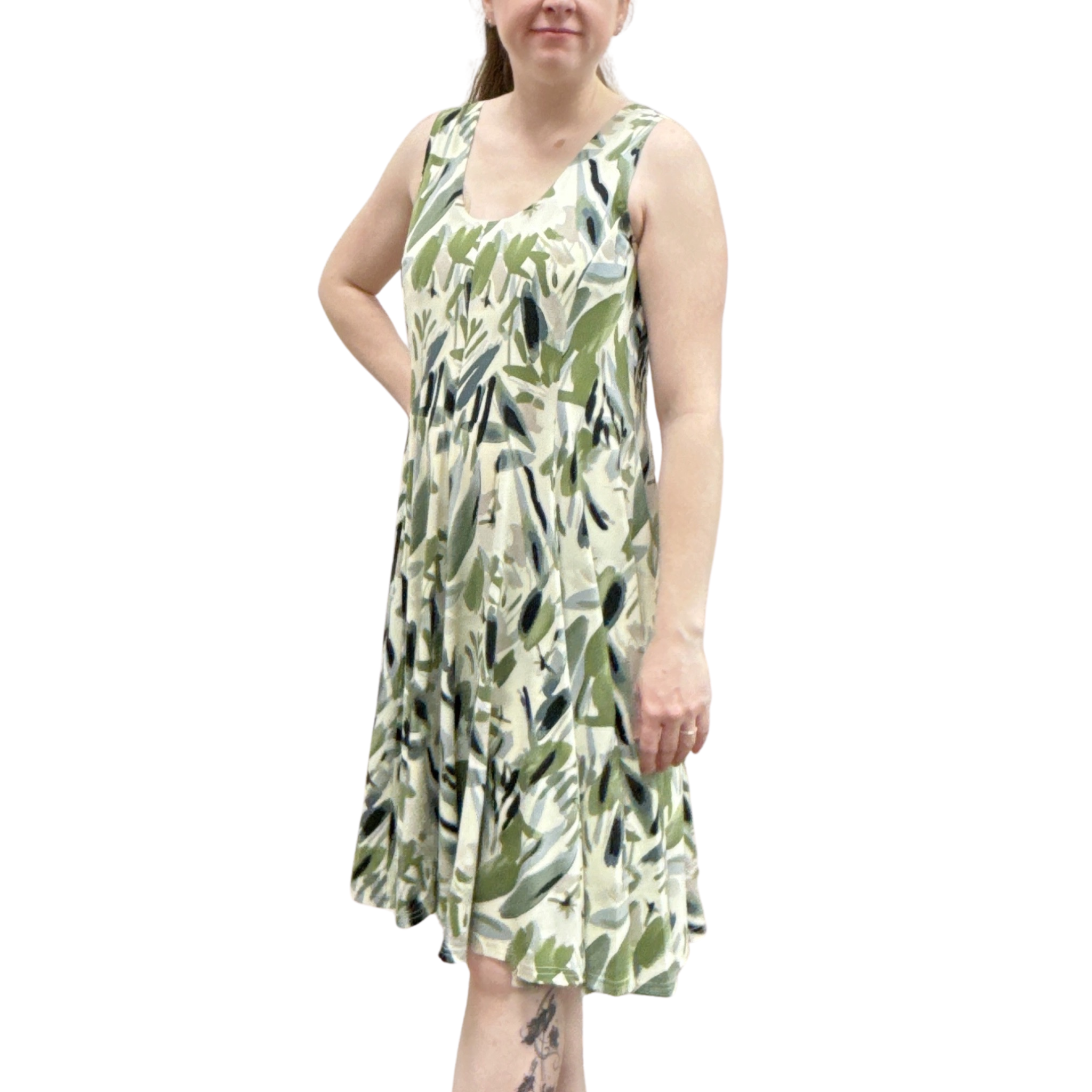 Woman wearing a green leaf-patterned dress on a white background