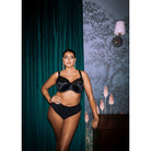 Lifestyle image of model wearing the Elomi Morgan in Black with matching underwear. 