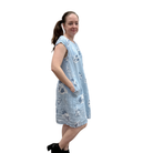 Woman wearing a light blue floral dress on a white background