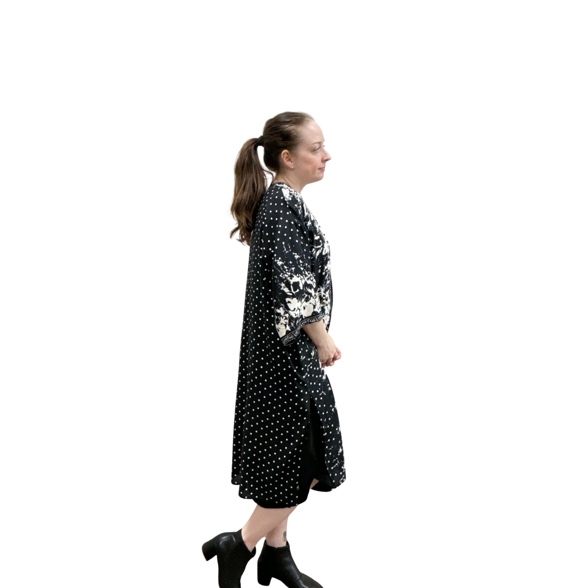 Woman wearing a black dress with white patterns on a white background