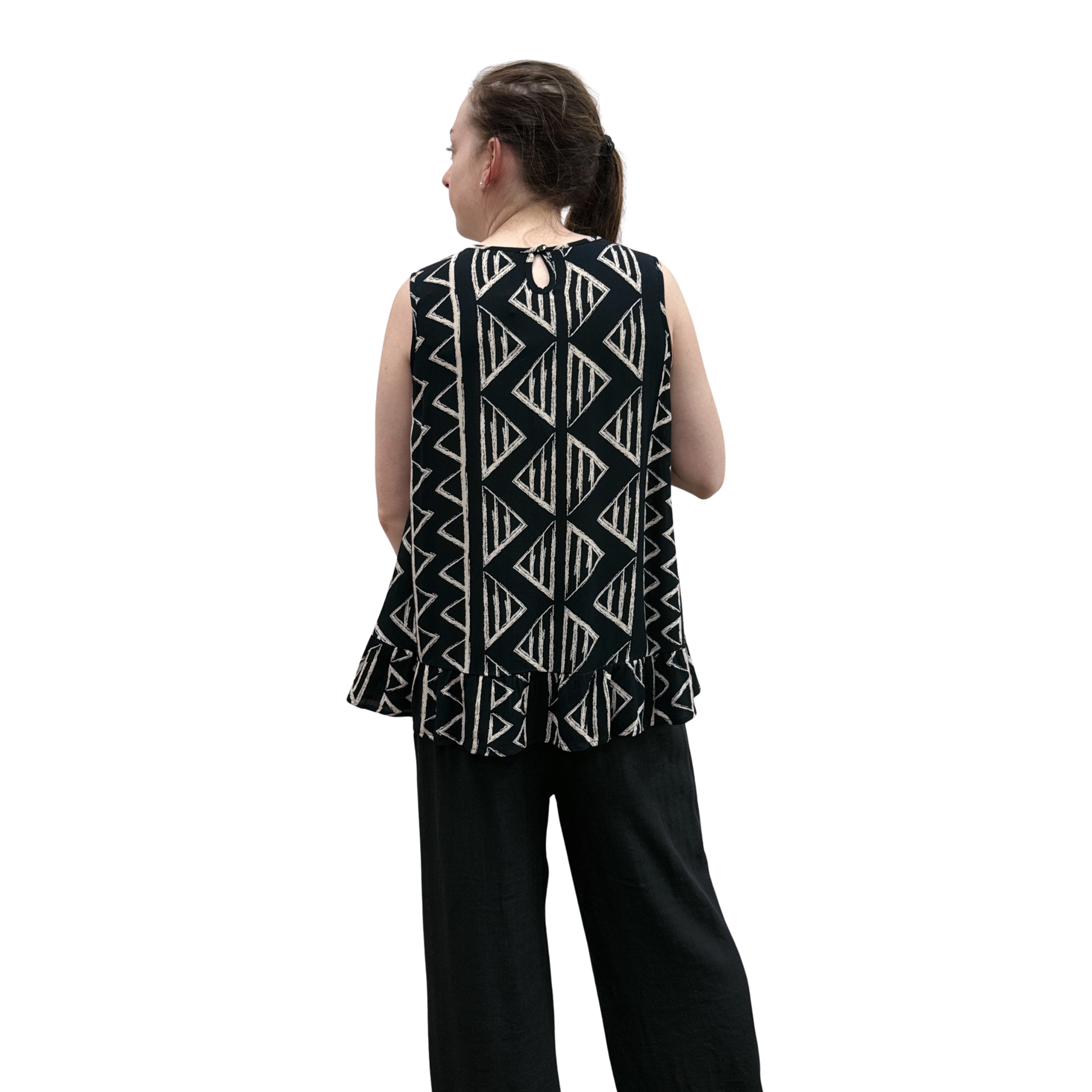 Woman wearing black with geometric print pattern sleeveless top with ruffle bottom on white background