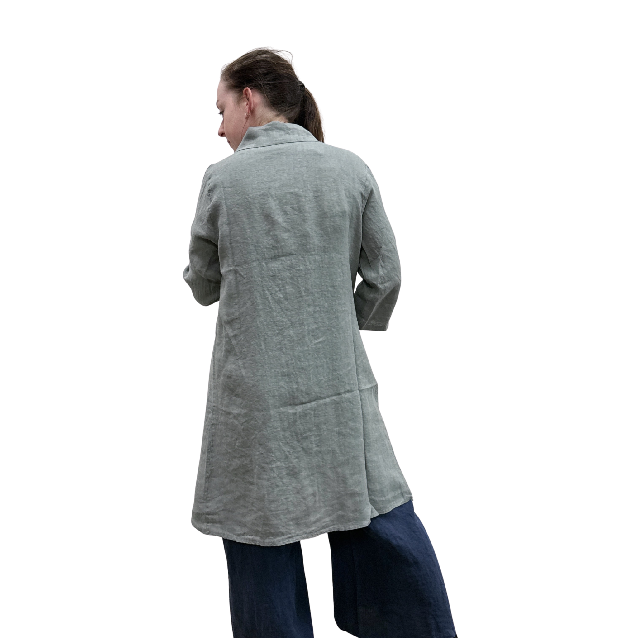 Woman wearing a long gray cardi over a dark jumpsuit on a white background