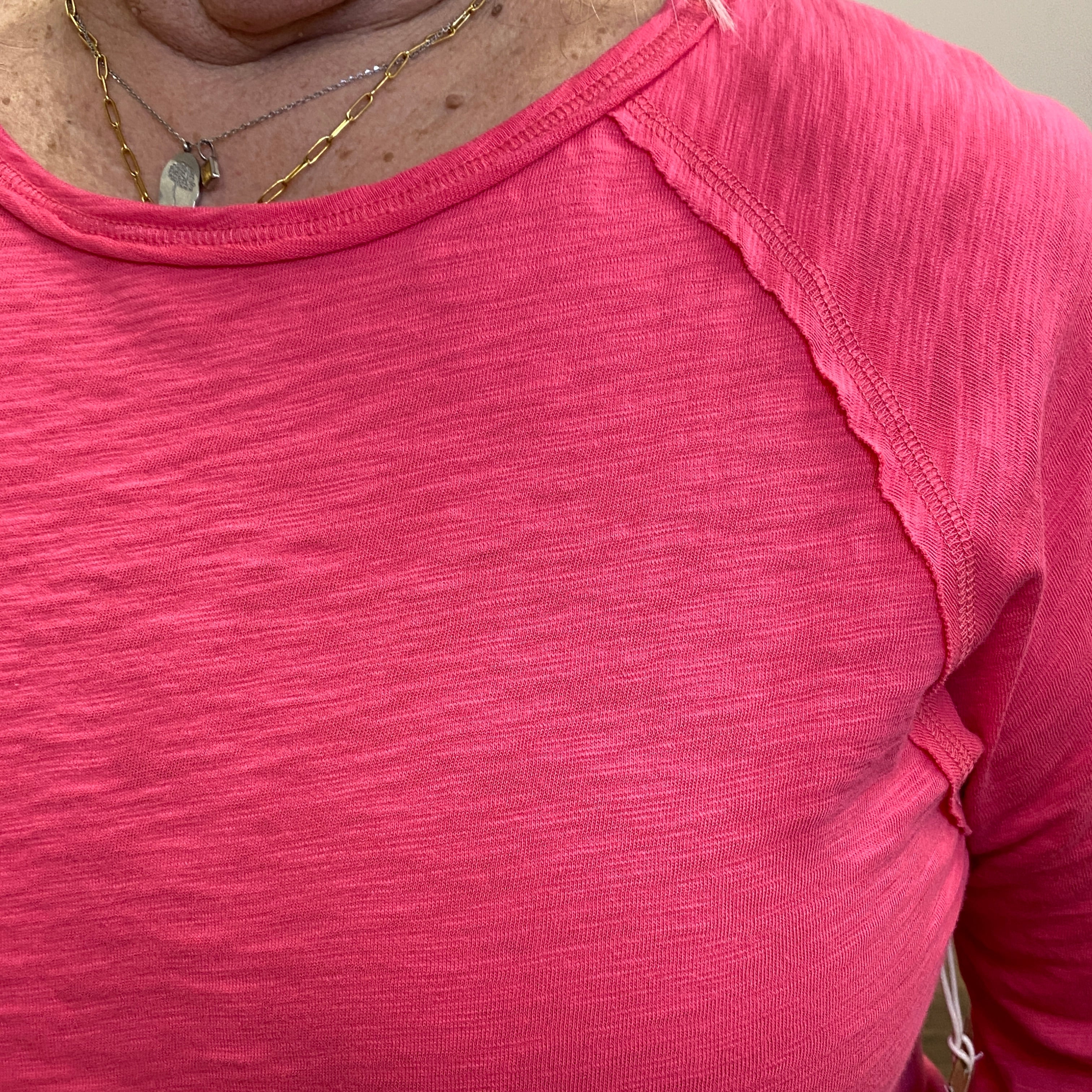 Close-up of a pink sleeveless top with a blurred background