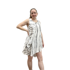 Woman wearing a white dress with black patterns on a white background