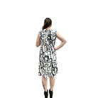 Woman wearing a sleeveless dress with a geometric pattern on a white background