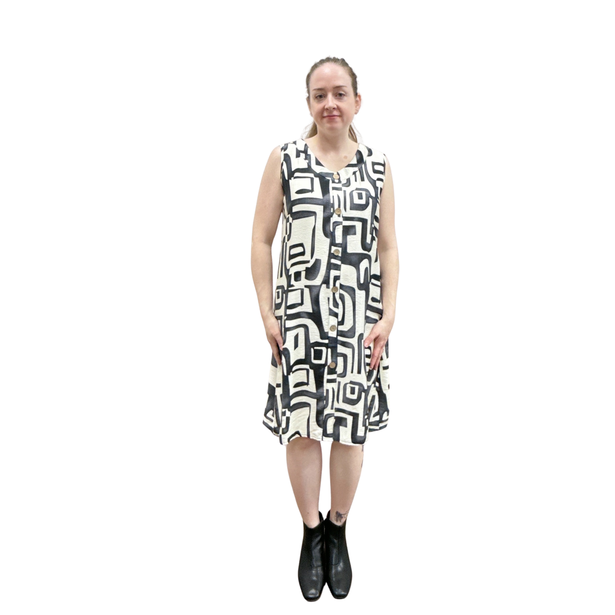 Woman wearing a sleeveless dress with a geometric pattern on a white background