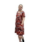 Woman wearing a red floral dress on a white background