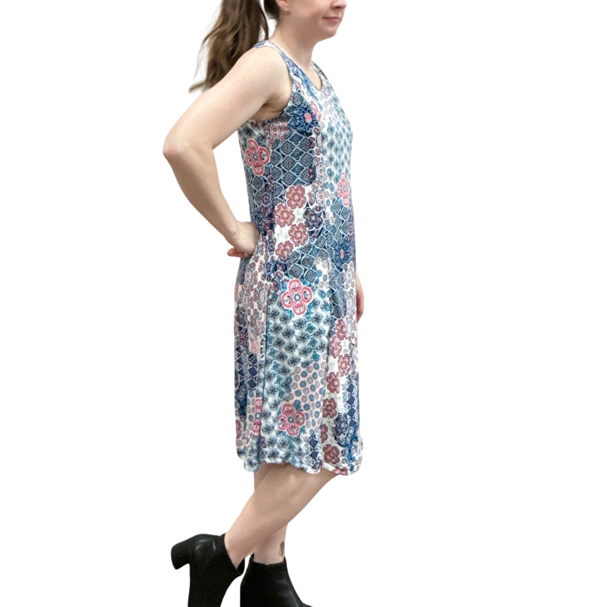 Woman wearing a sleeveless floral dress on a white background