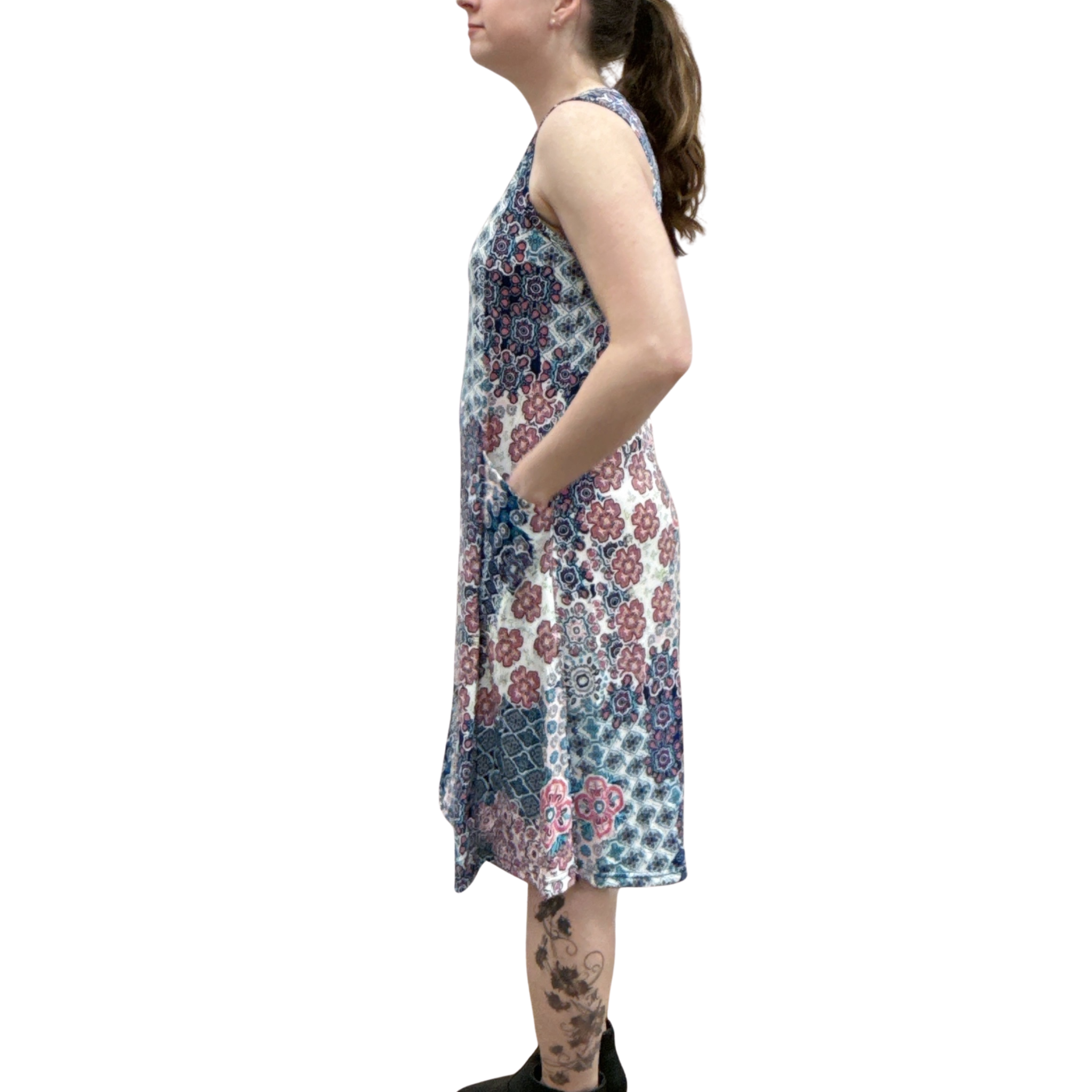 Woman wearing a sleeveless floral dress on a white background