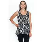 Woman wearing a black and white patterned sleeveless top on a white background