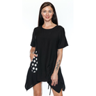 Woman wearing a black dress with a polka dot pattern on a white background