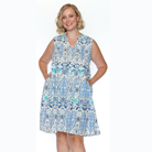 Woman wearing a sleeveless floral dress on a white background