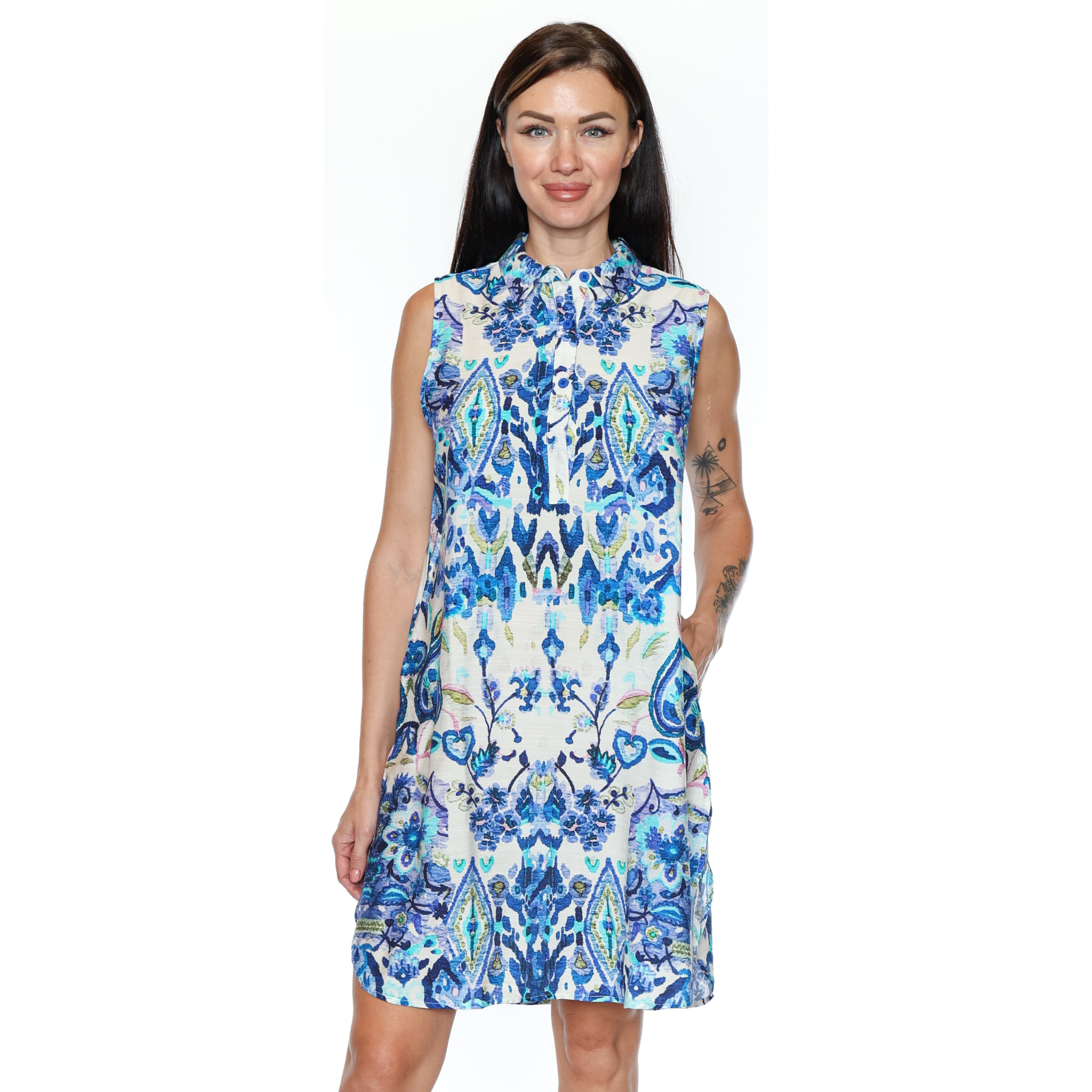 Woman wearing a sleeveless dress with a blue and white pattern on a white background