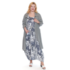Woman wearing a long gray cardigan over a patterned dress on a white background