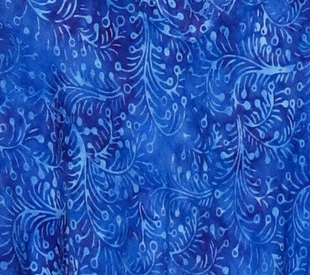 Woman wearing a blue patterned dress on a white background