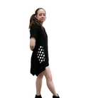 Woman wearing a black dress with white polka dot pattern on a white background