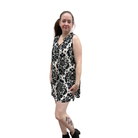 Woman wearing a black and white patterned dress on a white background