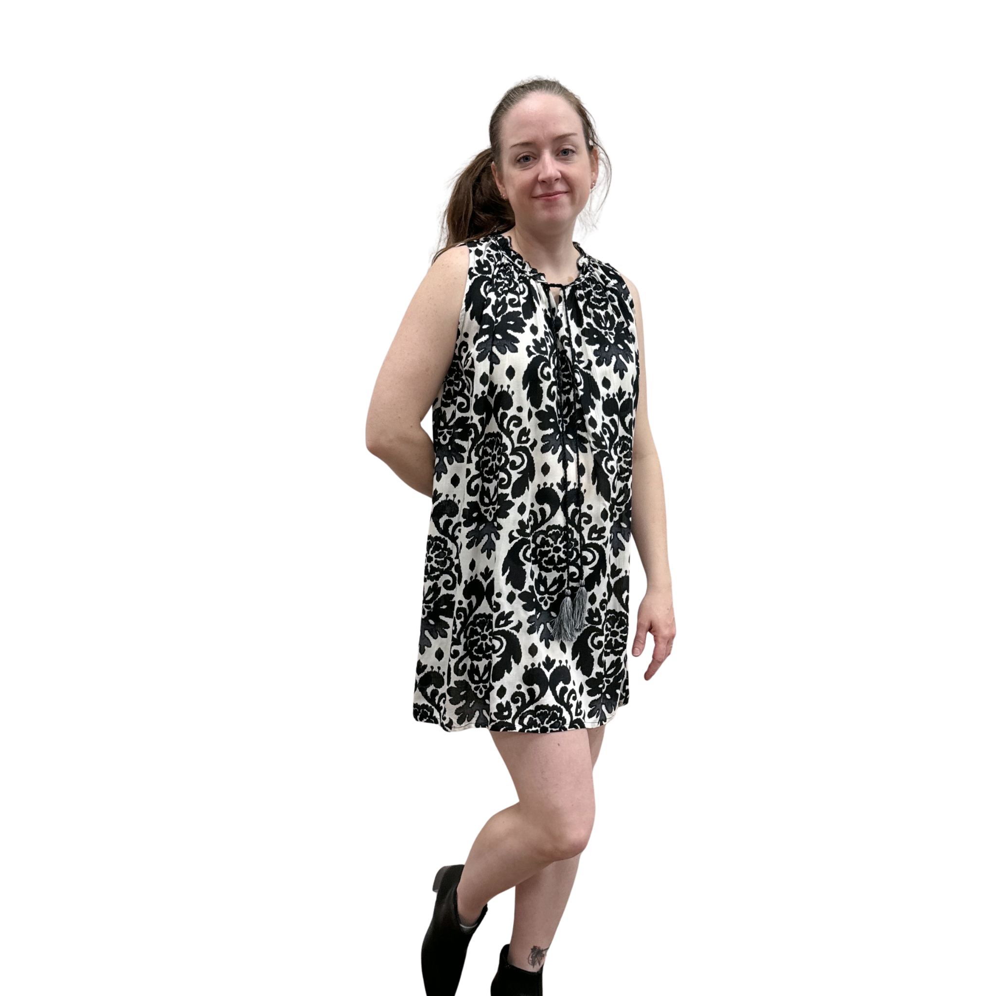 Woman wearing a black and white floral dress on a white background