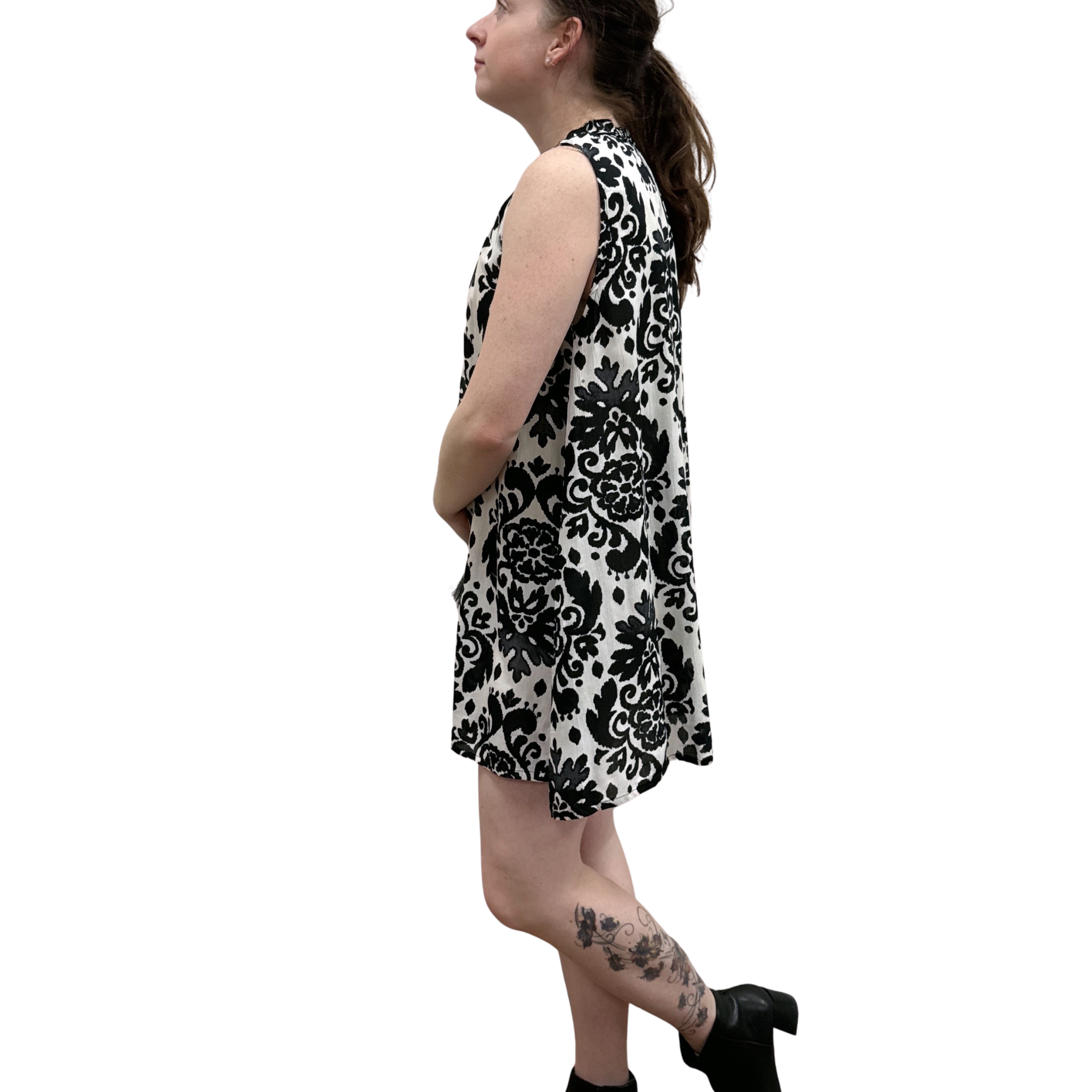 Woman wearing a black and white patterned dress on a white background