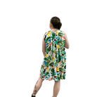 Woman wearing a colorful floral dress on a white background