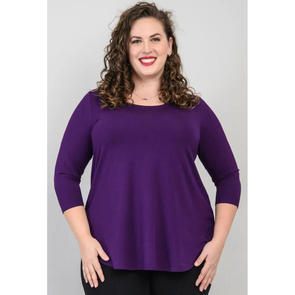 Blue Sky Jazz 3/4 Sleeve Top in Royale Purple shown on a model wearing black leggings against a white background, from the front view. 