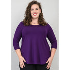 Blue Sky Jazz 3/4 Sleeve Top in Royale Purple shown on a model wearing black leggings against a white background, from the front view. 