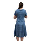 Woman wearing a blue dress from behind on a white background