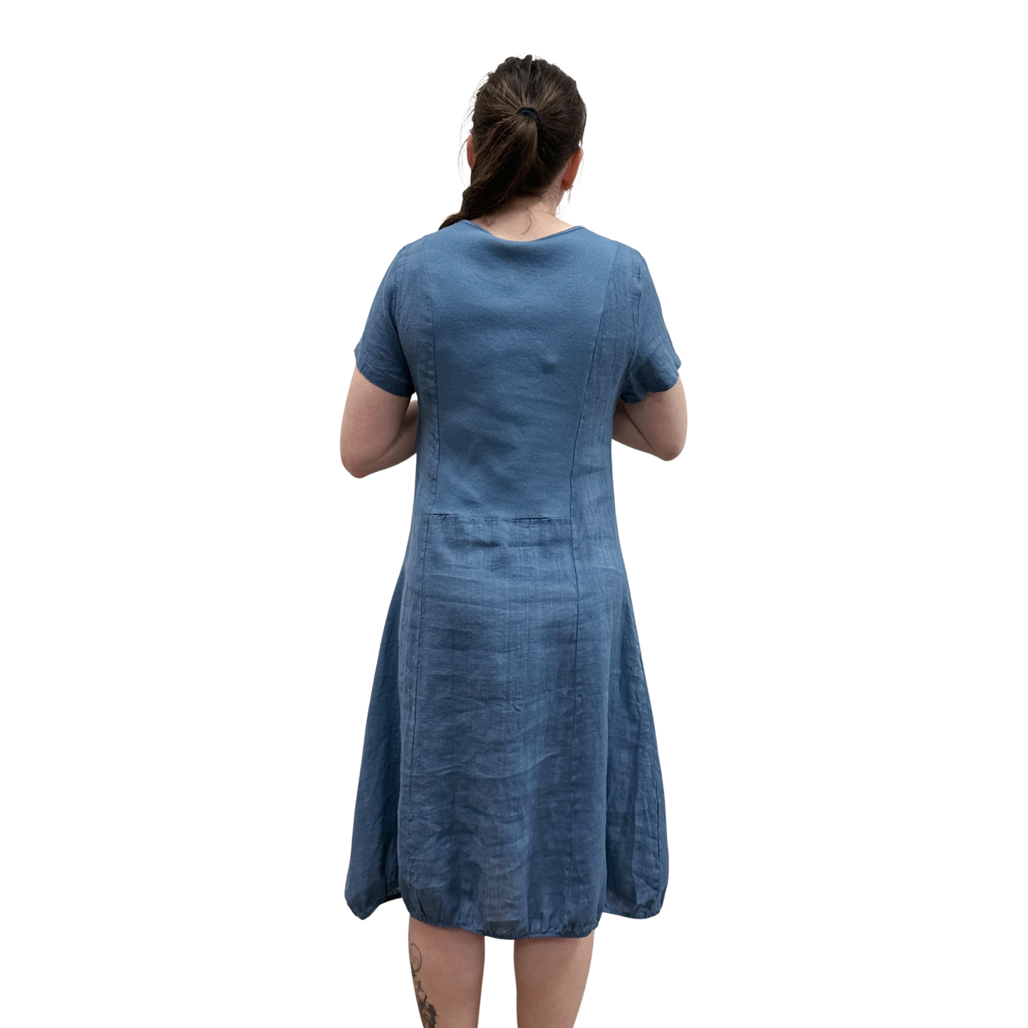 Woman wearing a blue dress from behind on a white background