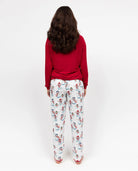 Person wearing a red top and patterned pants on a white background