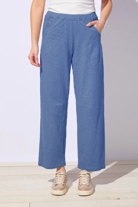 Person wearing blue pants with a white background