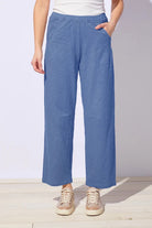 Person wearing blue pants with a white background