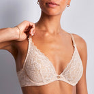 Aubade Rossence Plunge bra in Nude worn on a model against a white background. 