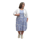 Woman wearing the Blue Sky Aldi Sweater in white over the blue Juni Dress on white background. 