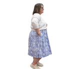 Woman wearing the Blue Sky Aldi Sweater in white over the blue Juni Dress on white background. 
