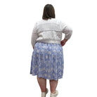 Woman wearing the Blue Sky Aldi Sweater in white over the blue Juni Dress on white background. 