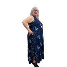 Woman wearing a navy floral Blue Sky Ari Dress on a white background. 