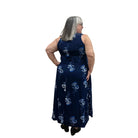 Woman wearing a navy floral Blue Sky Ari Dress on a white background. 