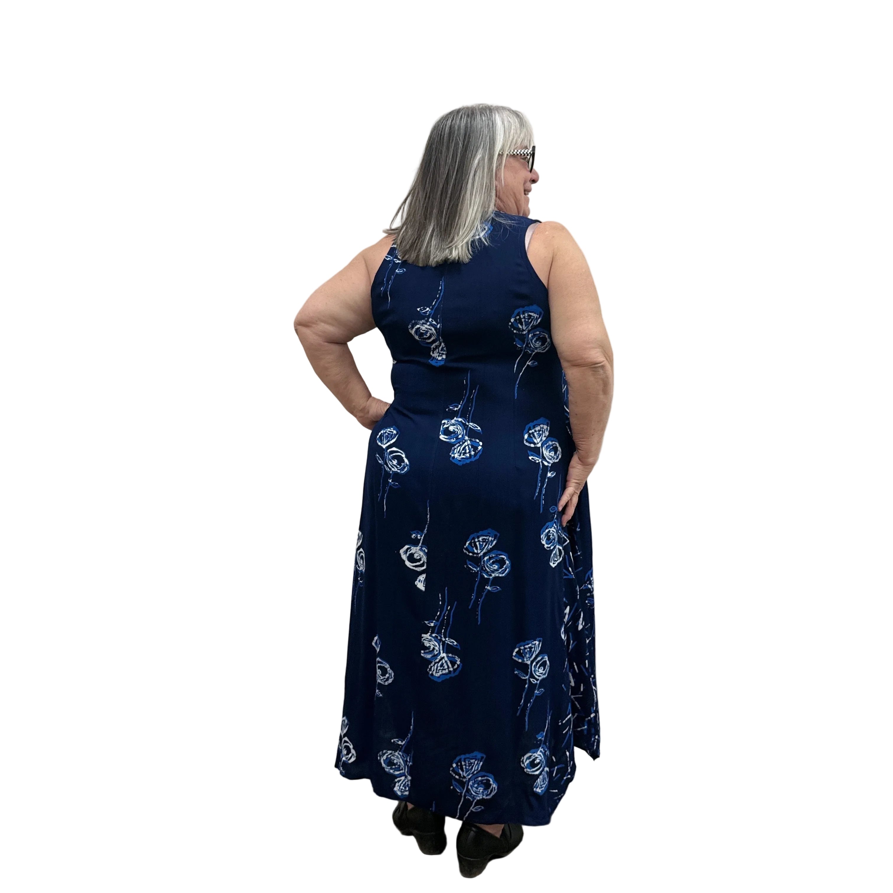 Woman wearing a navy floral Blue Sky Ari Dress on a white background. 